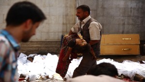 GRAPHIC CONTENT
A Syrian man carries a girl outside of a make-shift hospital following air strikes by Syrian government forces on a marketplace in the rebel-held area of Douma, east of the capital Damascus on August 16, 2015. At least 82 people were killed and 200 people were injured, with the death toll -most of them civilians- likely to rise as many of the wounded were in serious condition, the Syrian Observatory for Human Rights said.   
 AFP PHOTO / ABD DOUMANY        (Photo credit should read ABD DOUMANY/AFP/Getty Images)
