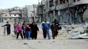 A handout picture released by the Syrian Arab News Agency (SANA) shows Syrians walking past destroyed buildings in the Baba Amr district of the central city of Homs on March 27, 2013. Forces loyal to Syria's President Bashar al-Assad have seized Baba Amr, a watchdog said on March 26, two weeks after fighting erupted in the flashpoint district. AFP PHOTO/HO/SANA   == RESTRICTED TO EDITORIAL USE - MANDATORY CREDIT "AFP PHOTO / HO / SANA" - NO MARKETING NO ADVERTISING CAMPAIGNS - DISTRIBUTED AS A SERVICE TO CLIENTS ==