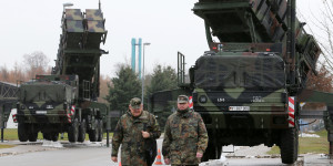 Soldiers of the Air Defence Missile Squadron 2 walk past Patriot missile launchers in the background in Bad Suelze, northern Germany  on December 4, 2012. Russian President Vladimir Putin warned that any deployment of US-made Patriot missiles on Turkey's volatile border with war-ravaged Syria would exacerbate tensions, and said the two countries had failed to overcome their sharp differences on the conflict. "Creating additional capabilities on the border does not defuse the situation but on the contrary exacerbates it," Putin told a press conference with Turkish Prime Minister Recep Tayyip Erdogan after talks in Istanbul.  AFP PHOTO / BERND WUSTNECK   GERMANY OUT        (Photo credit should read BERND WUSTNECK/AFP/Getty Images)