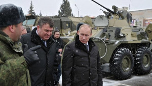 Russian Prime Minister and presidential candidate Vladimir Putin, right, examines military equipment and weapons during a visit to the Taman Motorized Infantry Brigade in Moscow on Wednesday, Feb. 22, 2012. Second left is Defense Minister Anatoly Serdyukov, at left is lieutenant colonel Andrei Alexeyev. (AP Photo/RIA-Novosti, Alexei Nikolsky, Government Press Service)