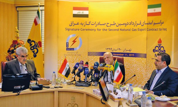 Iranian Oil Minister Bijan Namdar Zanganeh (C) Iraq's Deputy Energy Minister Khaled Hassan Saleh (L) and Iranian Deputy Oil Minister Hamid Reza Araqi attend a press conference in Tehran on November 11, 2015 after signing a contract that will nearly double Iran's daily natural gas exports to neighbouring country Iraq. The energy deal, to send 20 to 35 million cubic meters of gas per day to the southern Iraqi city of Basra, follows a first major deal between both countries in 2013 to export gas to the Iraqi capital Baghdad. AFP PHOTO / ATTA KENARE