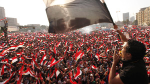 Protesters opposing Egyptian President Mohammed Morsi wave flags in Tahrir Square in Cairo on Wednesday. Shortly afterward, the military staged a coup, ousting Morsi and suspending the constitution.