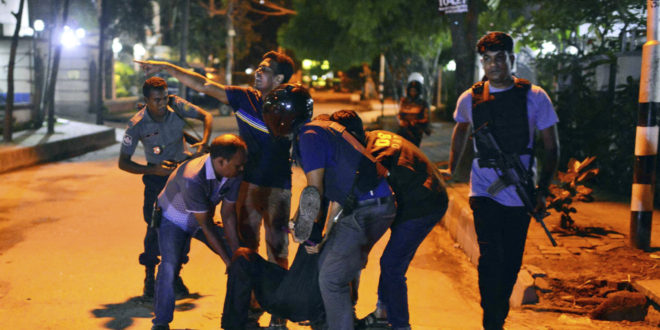 People help an unidentified injured person after a group of gunmen attacked a restaurant popular with foreigners in a diplomatic zone of the Bangladeshi capital Dhaka, Bangladesh, Friday, July 1, 2016. A group of gunmen attacked a restaurant popular with foreigners in a diplomatic zone of the Bangladeshi capital on Friday night, taking hostages and exchanging gunfire with security forces, according to a restaurant staff member and local media reports. (AP Photo)