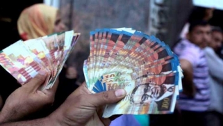 مسؤول فلسطيني يطالب بالإستغناء عن العملة الإسرائيلية للتخلص من التبعية الإقتصادية لإسرائيل